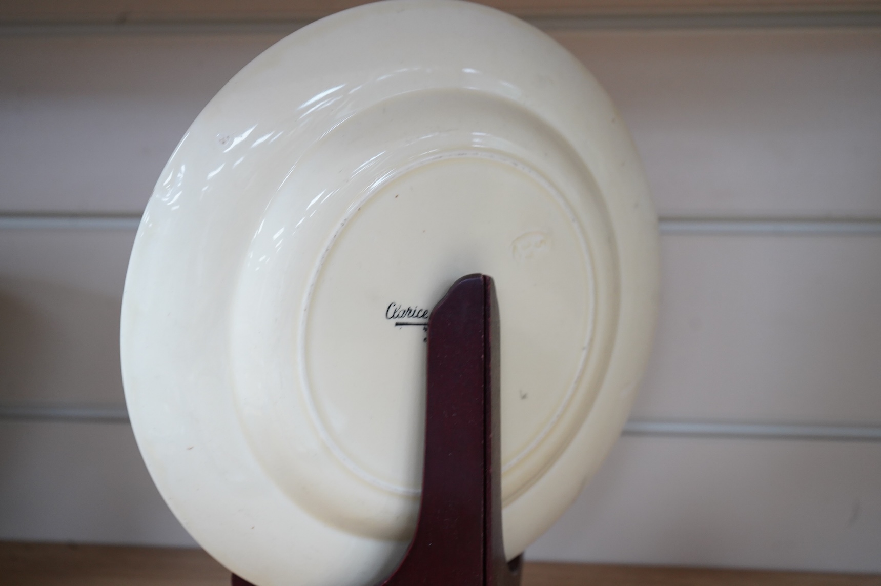 An early 20th century Clarice Cliff Bermuda pattern plate, Blue Autumn bowl and a Coral Firs Bizarre side plate, largest 23cm in diameter